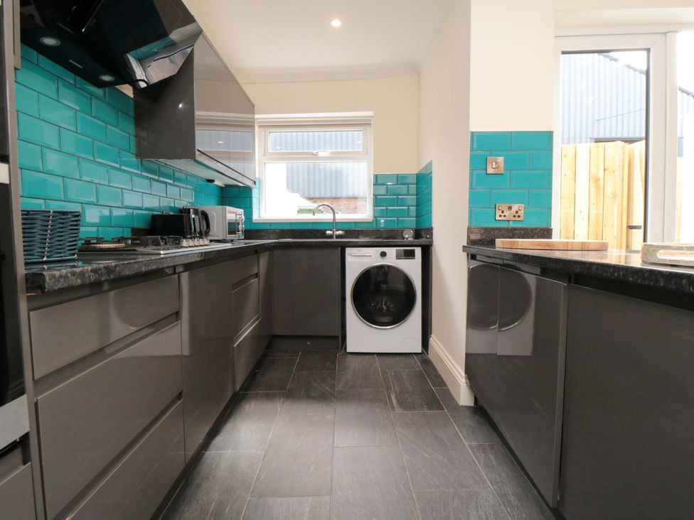 A kitchen with a washing machine and countertop at No.8 Trafalgar St West Scarborough