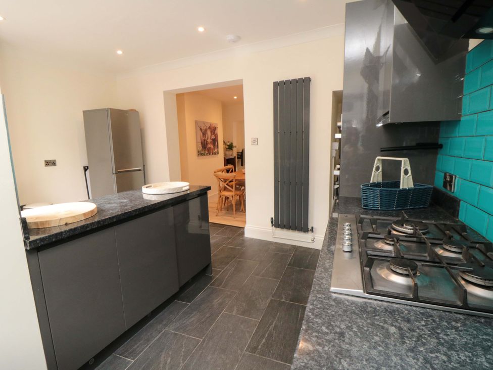 A kitchen with a fridge and gas stove at No.8 Trafalgar St West Scarborough