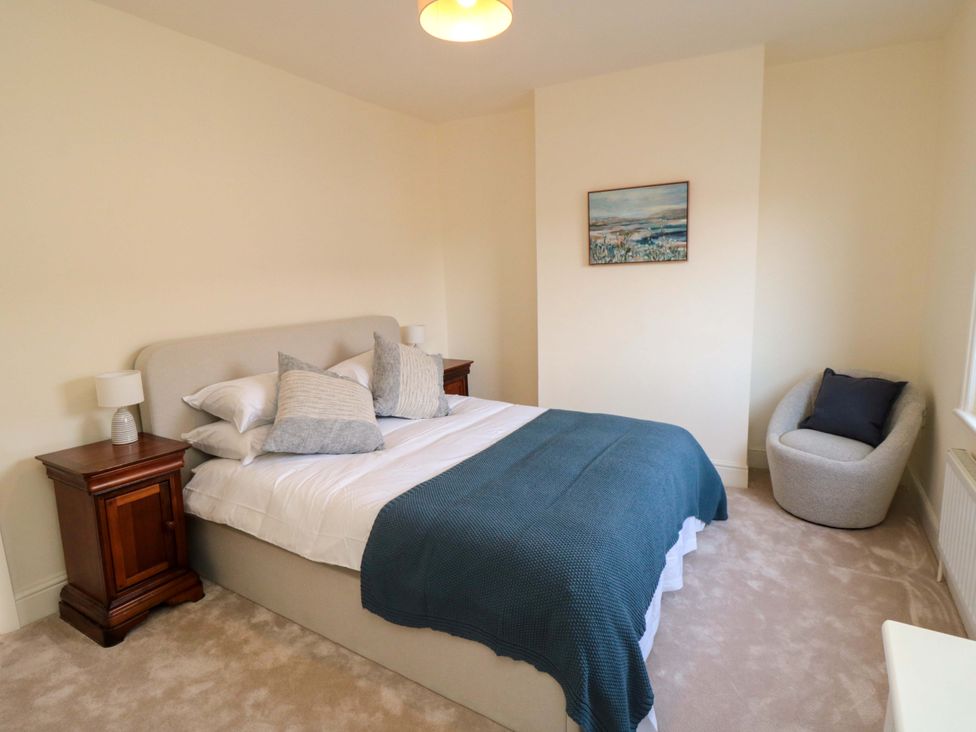 A bedroom with a bed and bedside tables at No.8 Trafalgar St West in Scarborough