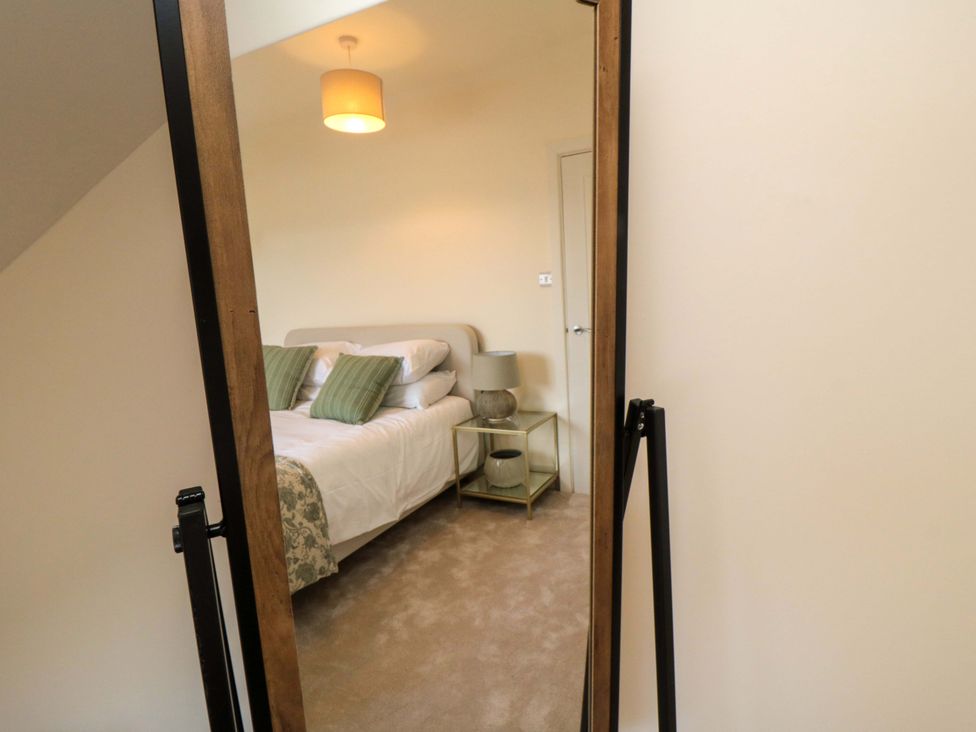 A bedroom featuring a bed with pillows and a lamp at No.8 Trafalgar St West, Scarborough