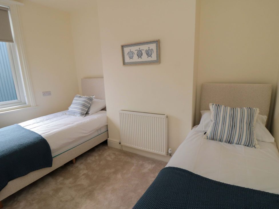 A bedroom with two single beds and a radiator at No.8 Trafalgar St West Scarborough
