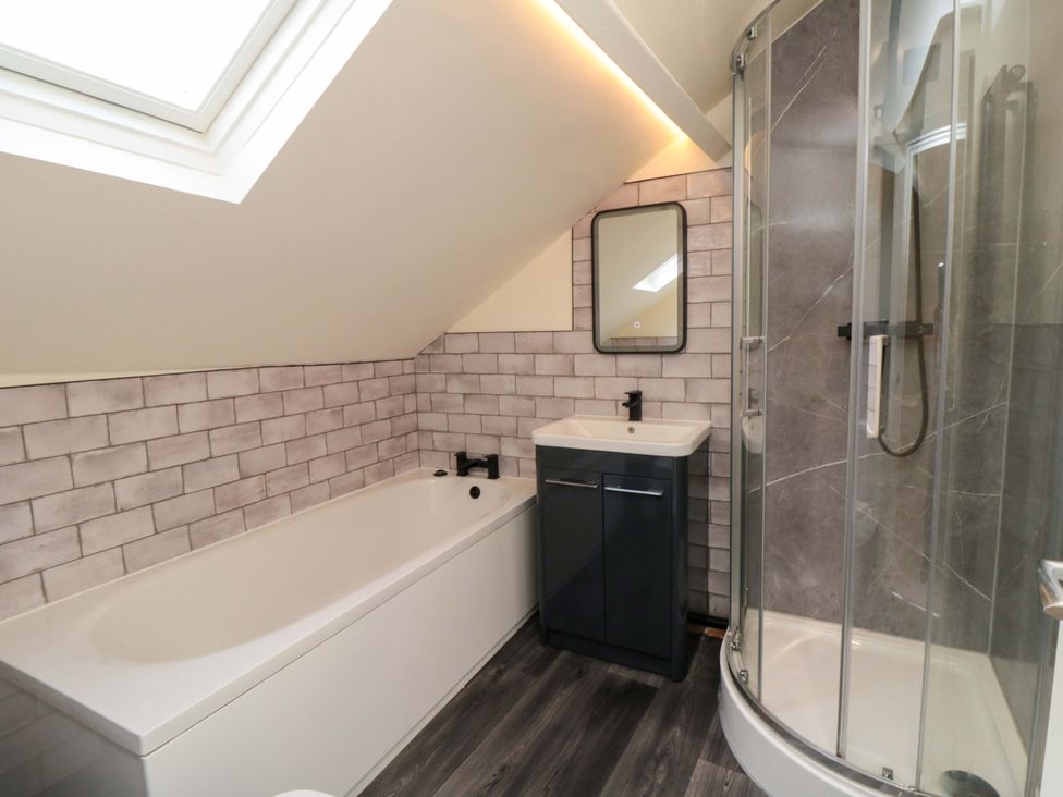 A bathroom with a bathtub and shower at No.8 Trafalgar St West in Scarborough