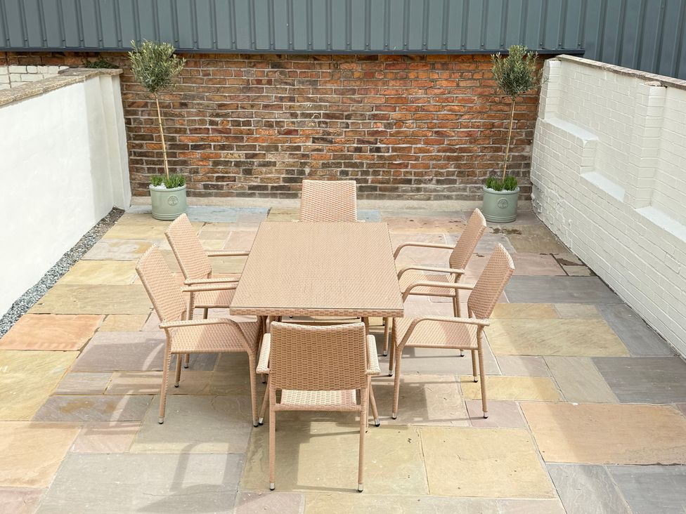 An outdoor dining area with a table and chairs at Trafalgar I in Scarborough