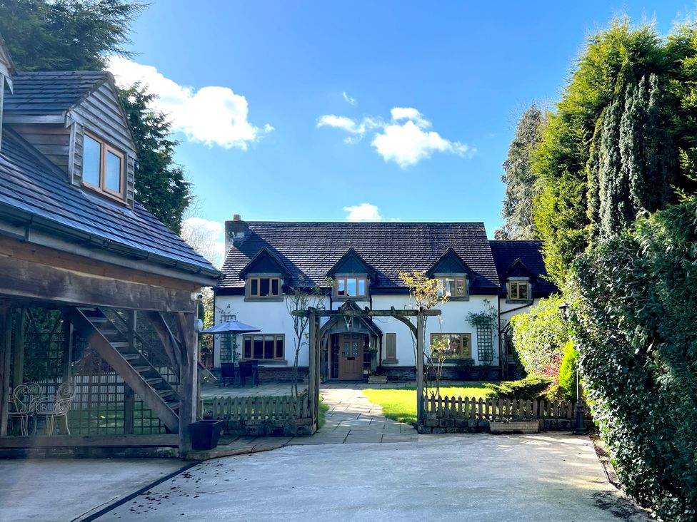 A house with a driveway and garden at The Oaks in Great Harwood