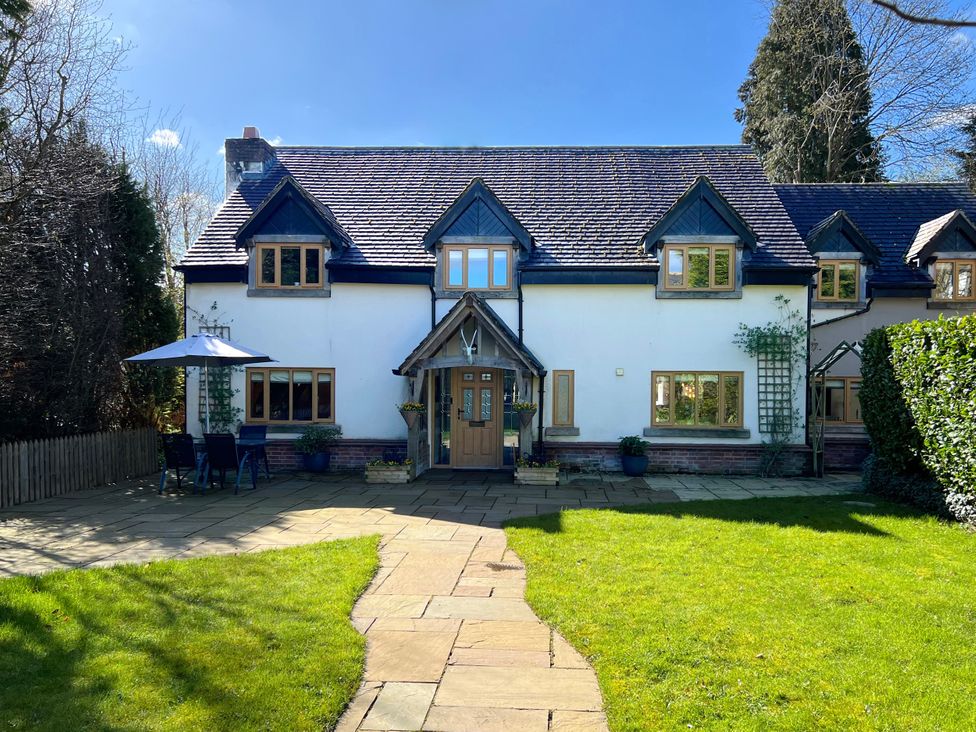 A house with a pathway and outdoor seating area at The Oaks in Great Harwood