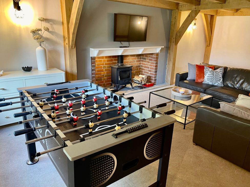 A game room with a foosball table and a sofa at The Oaks in Great Harwood