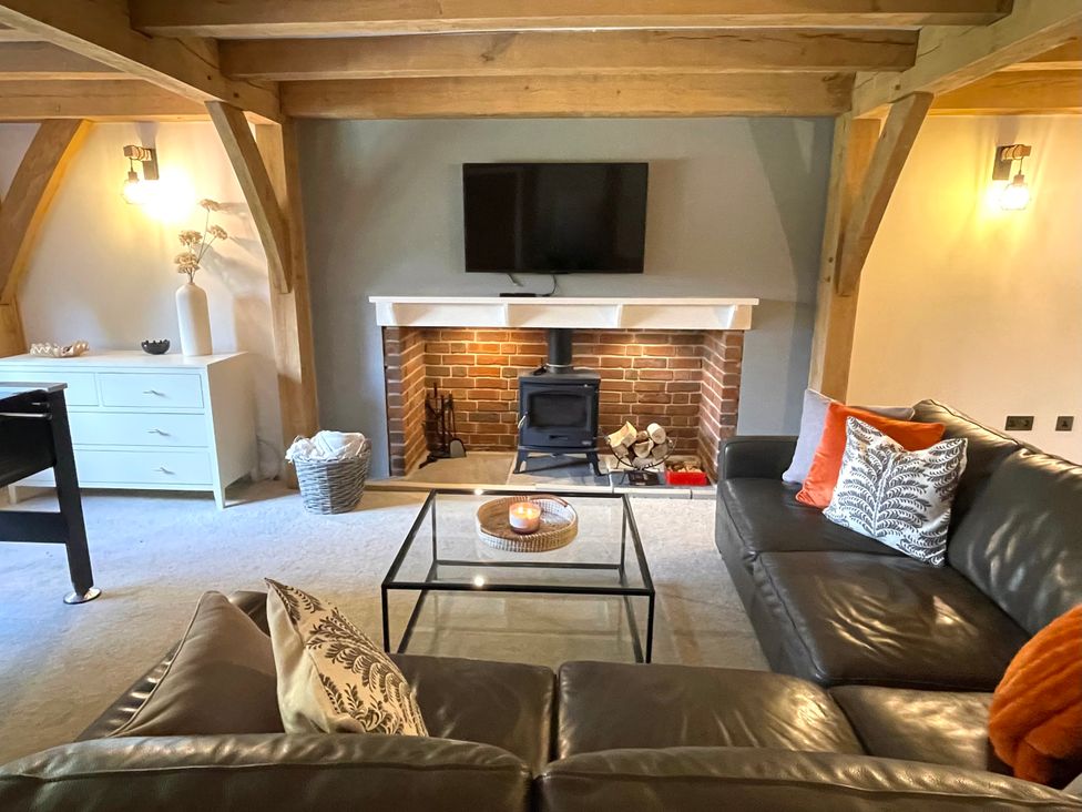 A living room with a sofa and a fireplace at The Oaks in Great Harwood