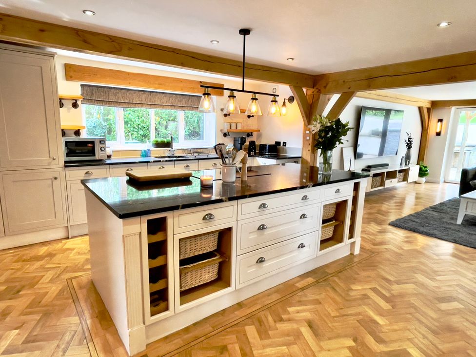 A kitchen with cabinets and an island at The Oaks in Great Harwood