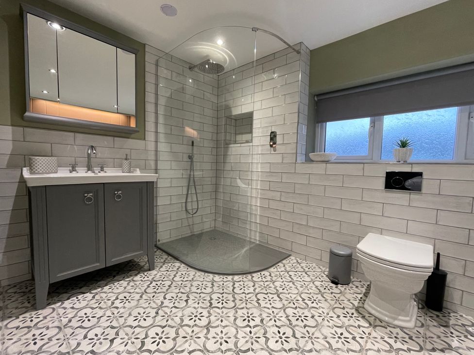 A bathroom with a shower and sink at The Oaks in Great Harwood