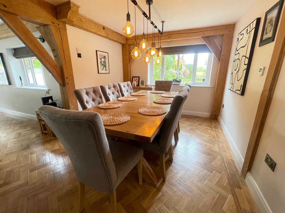 A dining room with a table and chairs at The Oaks in Great Harwood