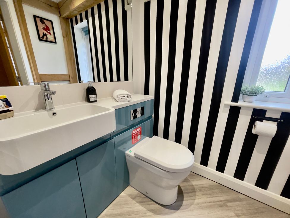 A bathroom with a sink and toilet at The Oaks in Great Harwood