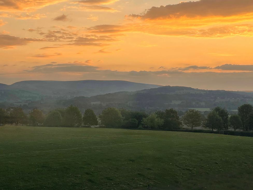 A landscape with mountains and trees during sunset at The Oaks in Great Harwood