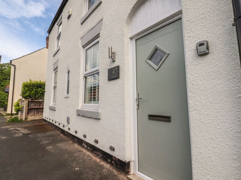 The entrance of a house with a green door and windows at 47 Grape Lane Croston