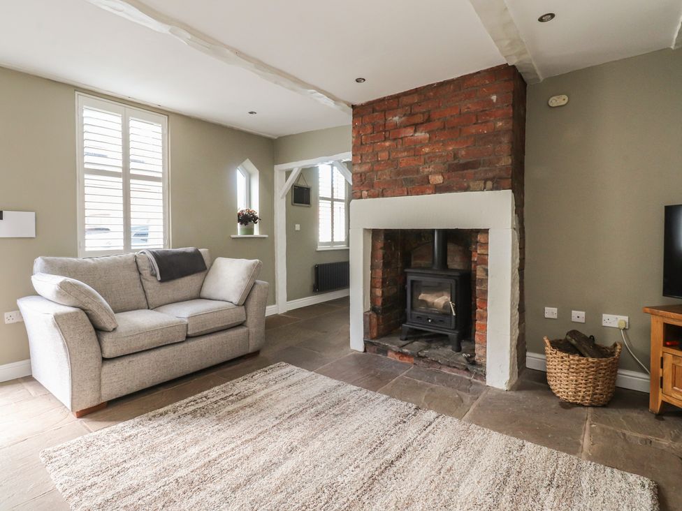 A living room with a fireplace and sofa at 47 Grape Lane in Croston