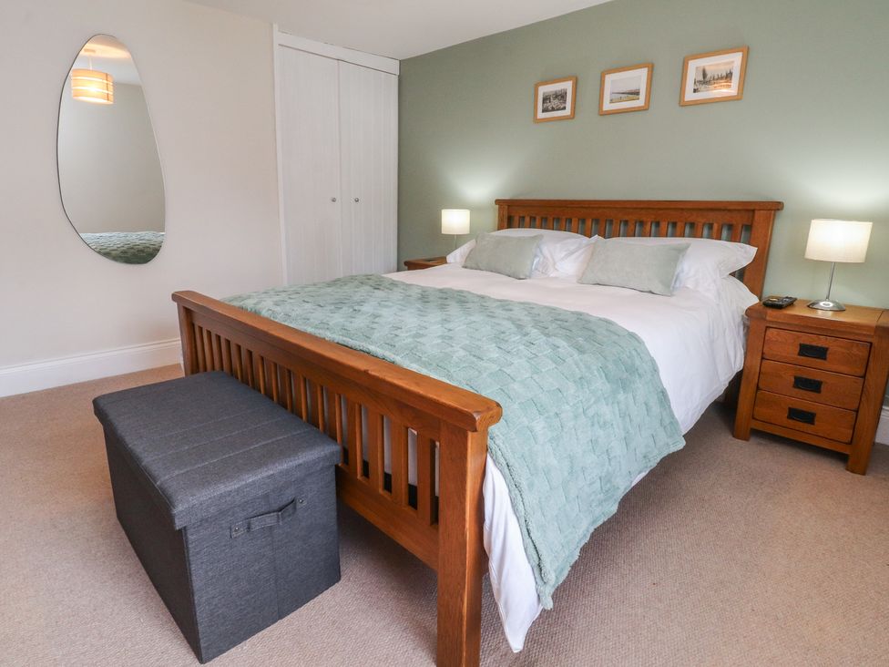 A bedroom with a bed and bedside tables at 47 Grape Lane Croston