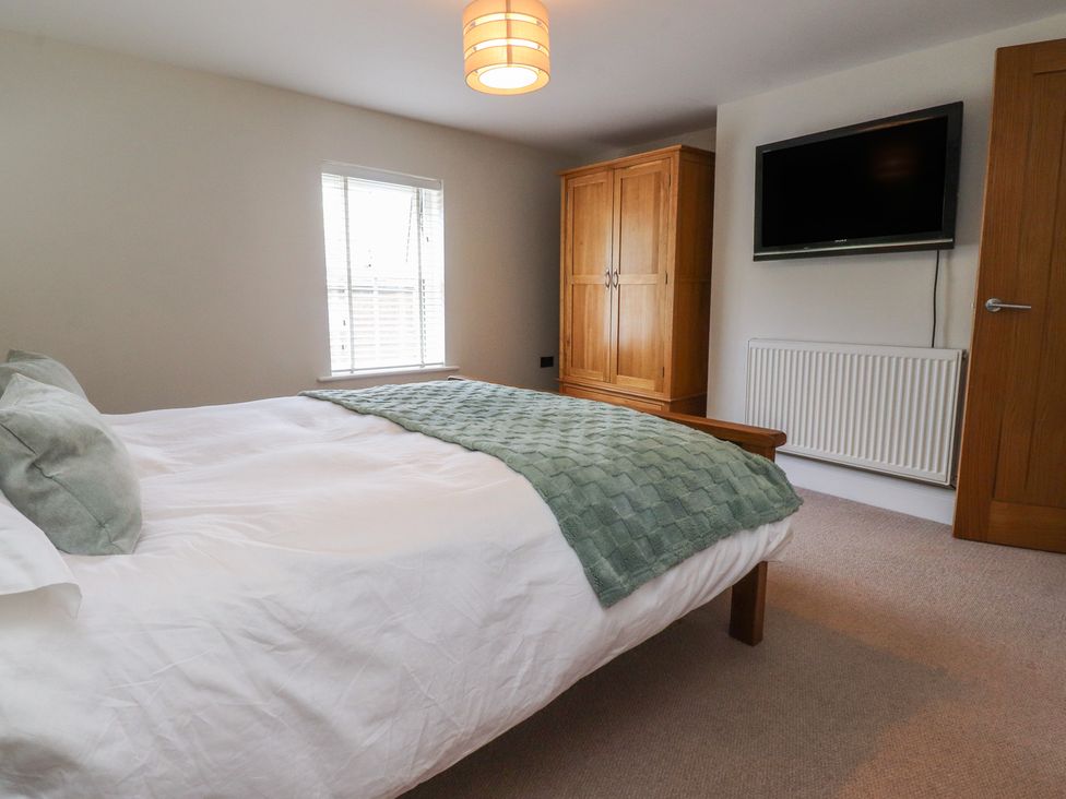 A bedroom with a bed and television at 47 Grape Lane in Croston