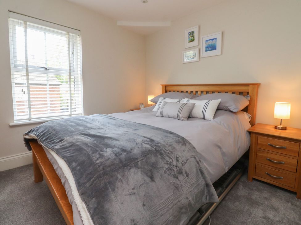 A bedroom with a bed and bedside tables at 47 Grape Lane in Croston