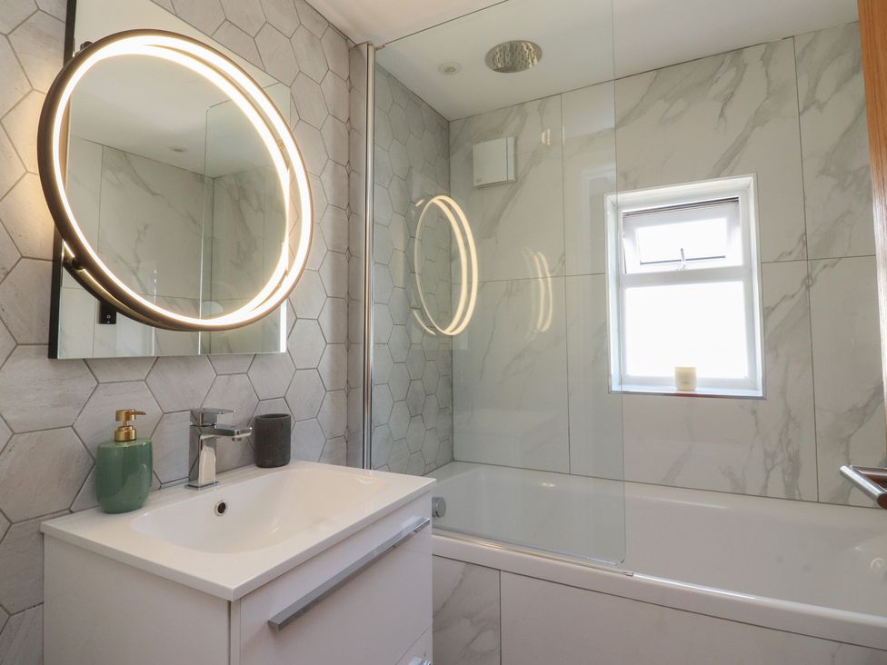 A bathroom with a sink and bathtub at 47 Grape Lane in Croston