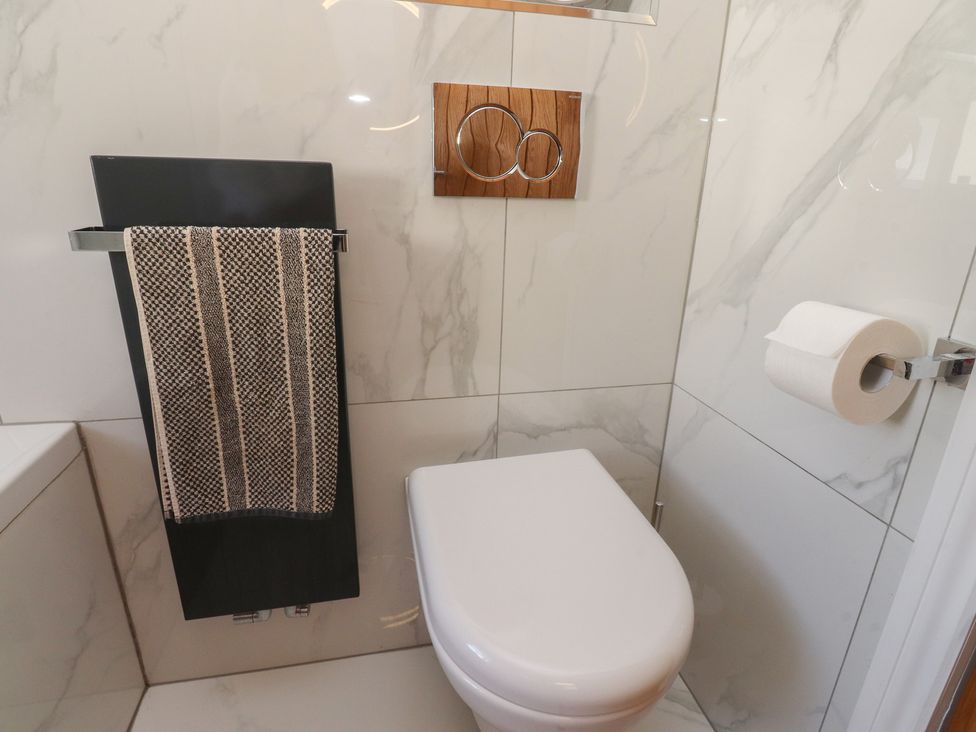 A bathroom with a toilet and towel rack at 47 Grape Lane Croston