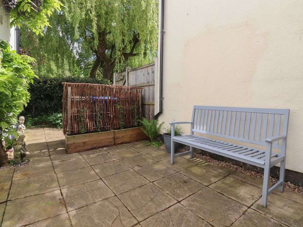 A garden with a bench next to a planter at 47 Grape Lane Croston
