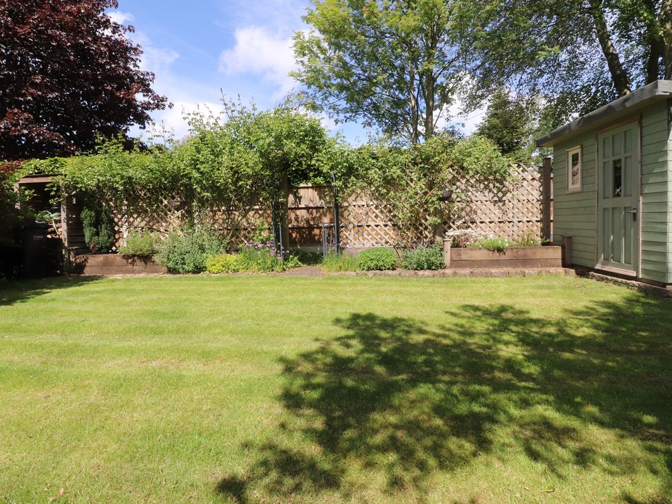 A garden with a shed and flowerbed at 47 Grape Lane Croston