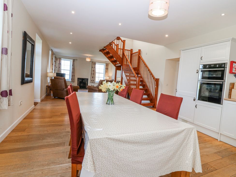 A dining room with a table and chairs at Meadowgreen Farmhouse, Forfar
