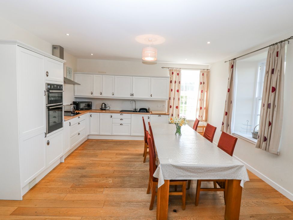 A kitchen with a table and chairs at Meadowgreen Farmhouse in Forfar