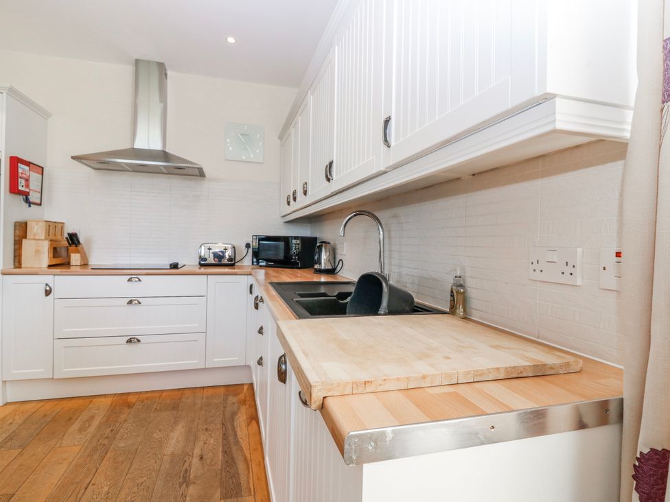 A kitchen with a sink and appliances at Meadowgreen Farmhouse in Forfar