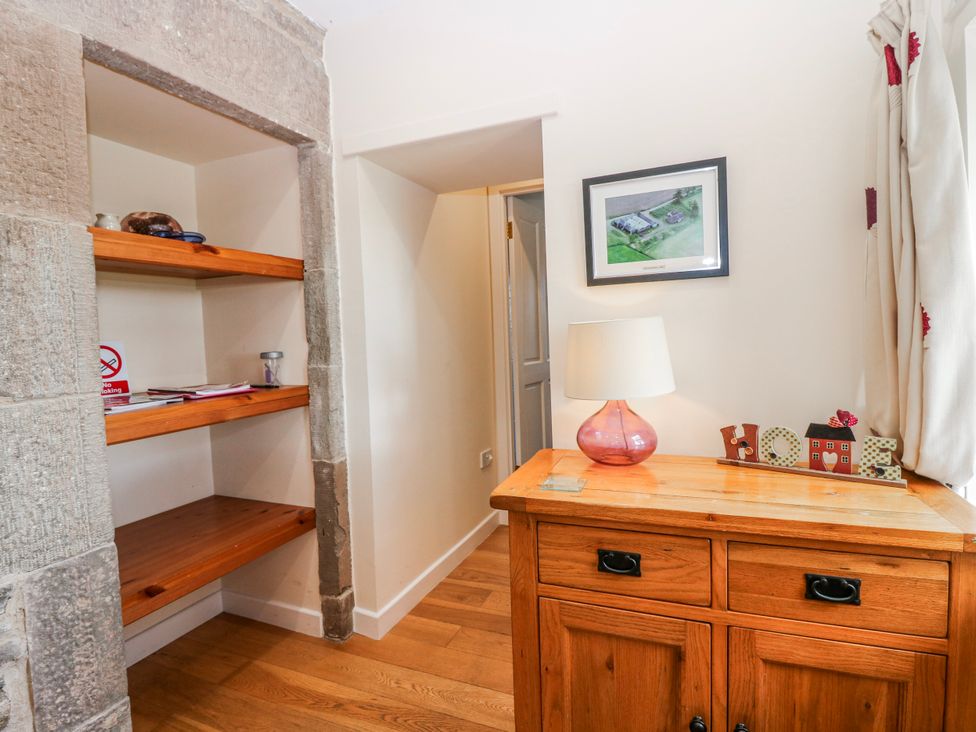 An entryway with shelves and a lamp at Meadowgreen Farmhouse in Forfar
