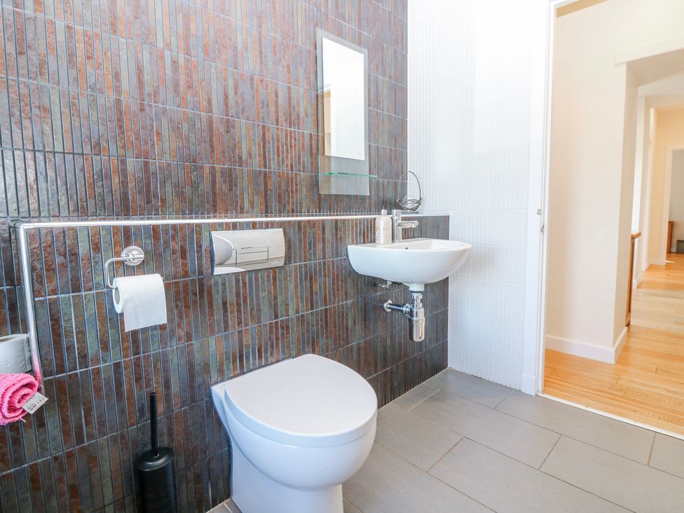 A bathroom with a sink and toilet at Meadowgreen Farmhouse Forfar