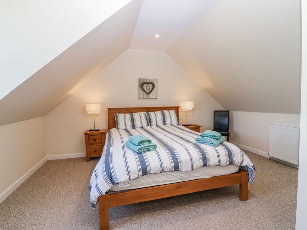 A bedroom with a bed and bedside table at Meadowgreen Farmhouse in Forfar