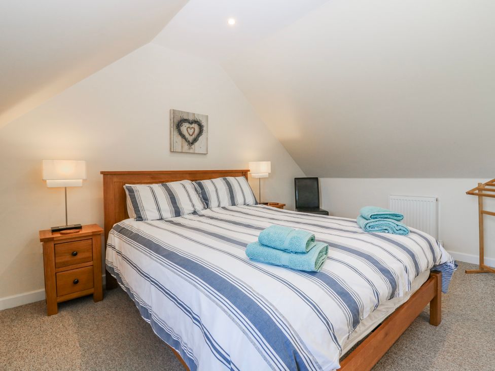 A bedroom with a bed and nightstand at Meadowgreen Farmhouse in Forfar