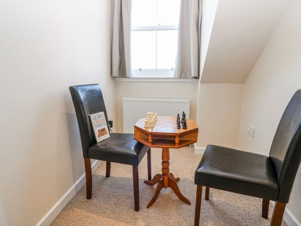 A games room with a chess set and chairs at Meadowgreen Farmhouse Forfar