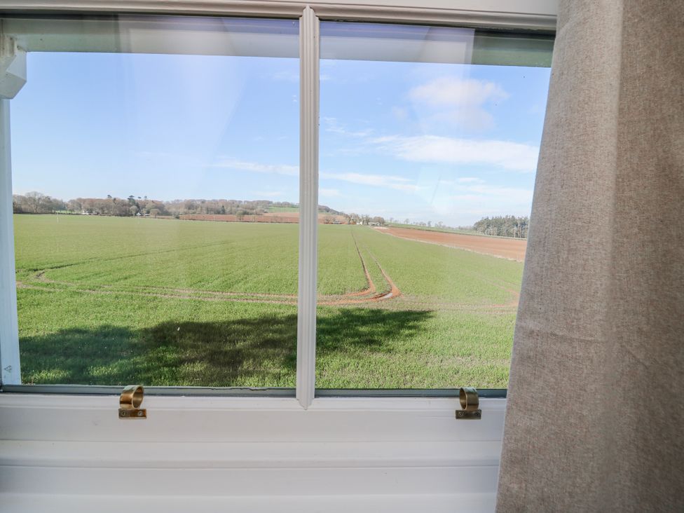 A view of a field from a window at Meadowgreen Farmhouse in Forfar