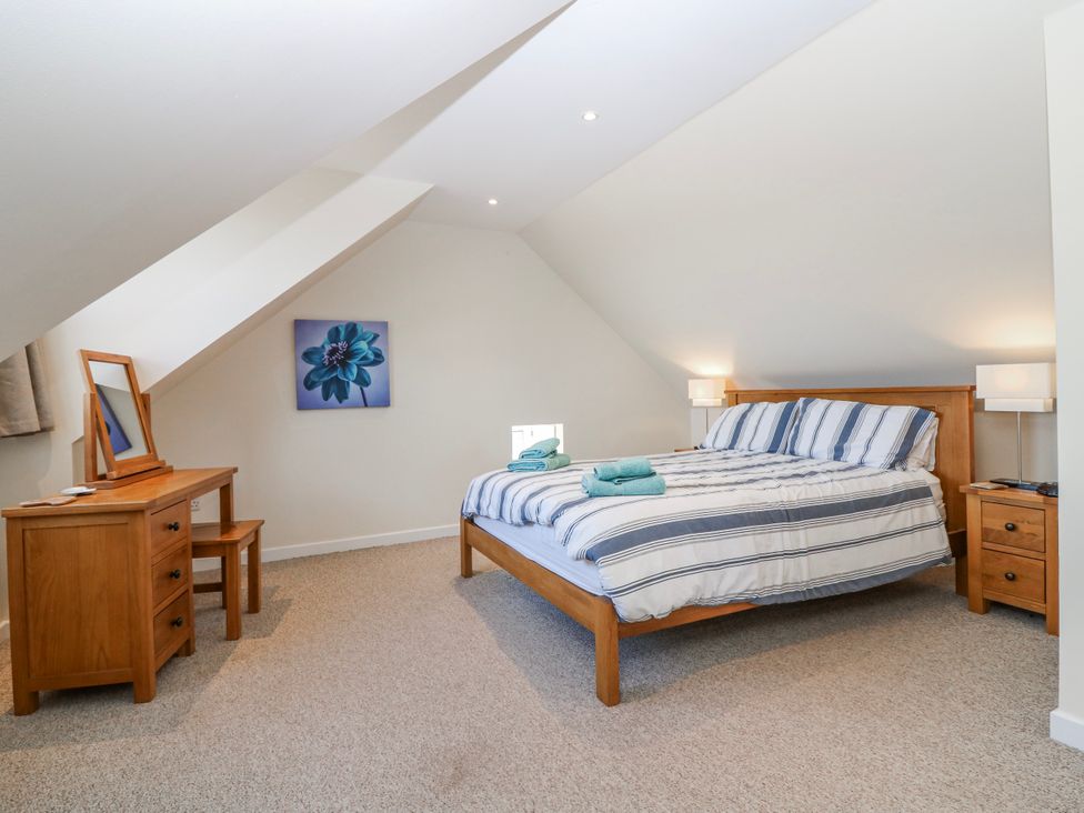 A bedroom with a bed and dresser at Meadowgreen Farmhouse in Forfar