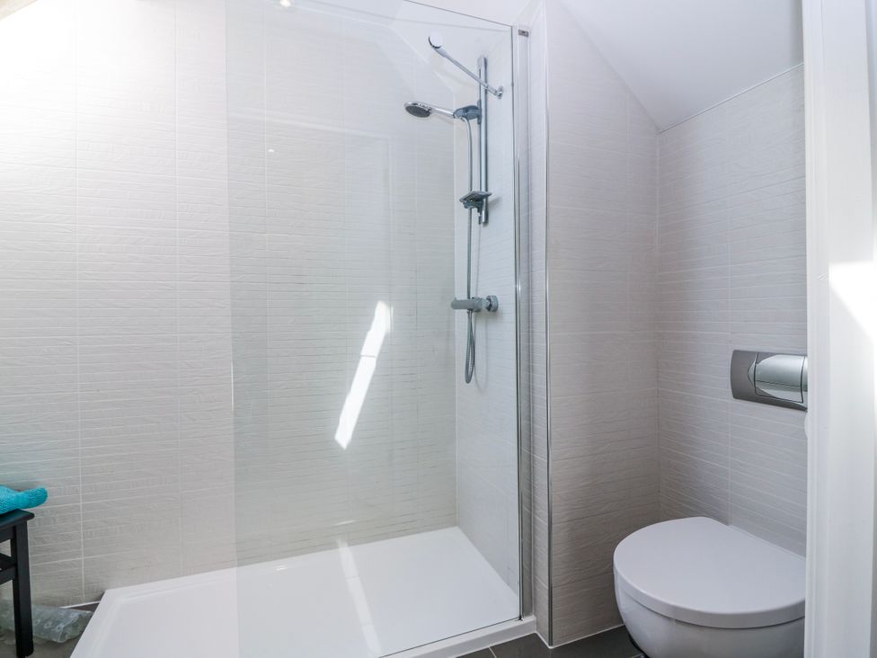 A bathroom with a shower and toilet at Meadowgreen Farmhouse in Forfar