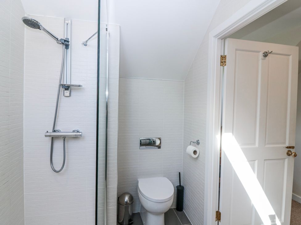 A bathroom with a shower and toilet at Meadowgreen Farmhouse in Forfar