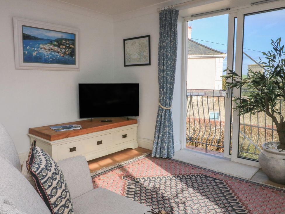 A living room with a television and sofa at 4 The Elms in Salcombe