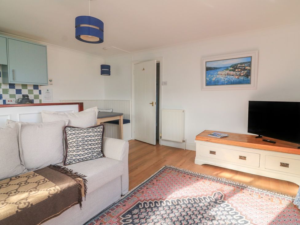 A living room with a sofa and television at 4 The Elms in Salcombe