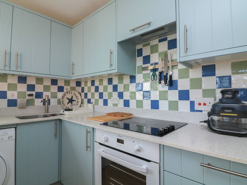 A kitchen with cabinets and an oven at 4 The Elms in Salcombe