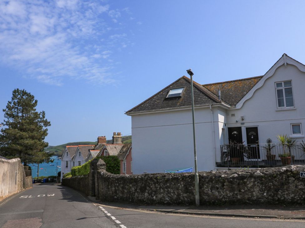 A view of houses and a road with an ocean in the background at 4 The Elms Salcombe