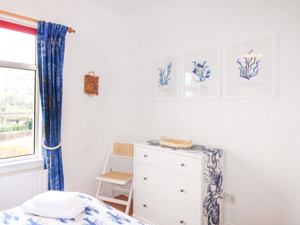 A bedroom with a window and dresser at 4 The Elms Salcombe