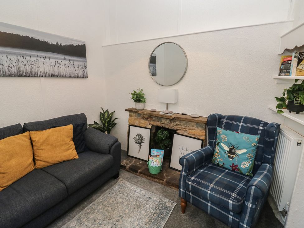 A living room with a sofa and armchair at The Cottage in Budleigh Salterton