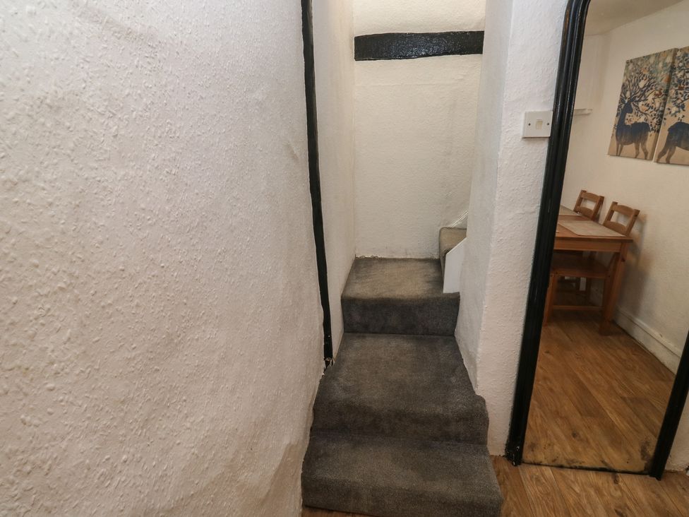 A staircase and a dining area in a hallway at The Cottage Budleigh Salterton