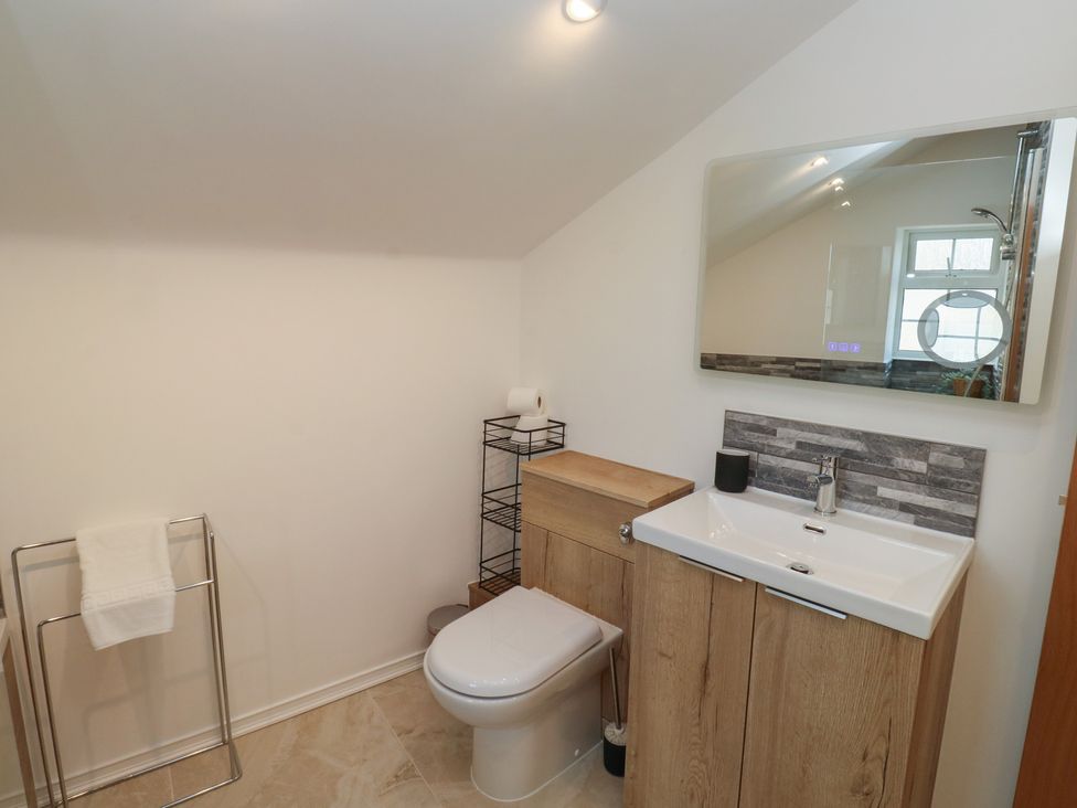 A bathroom with a toilet and sink at The Cottage Budleigh Salterton