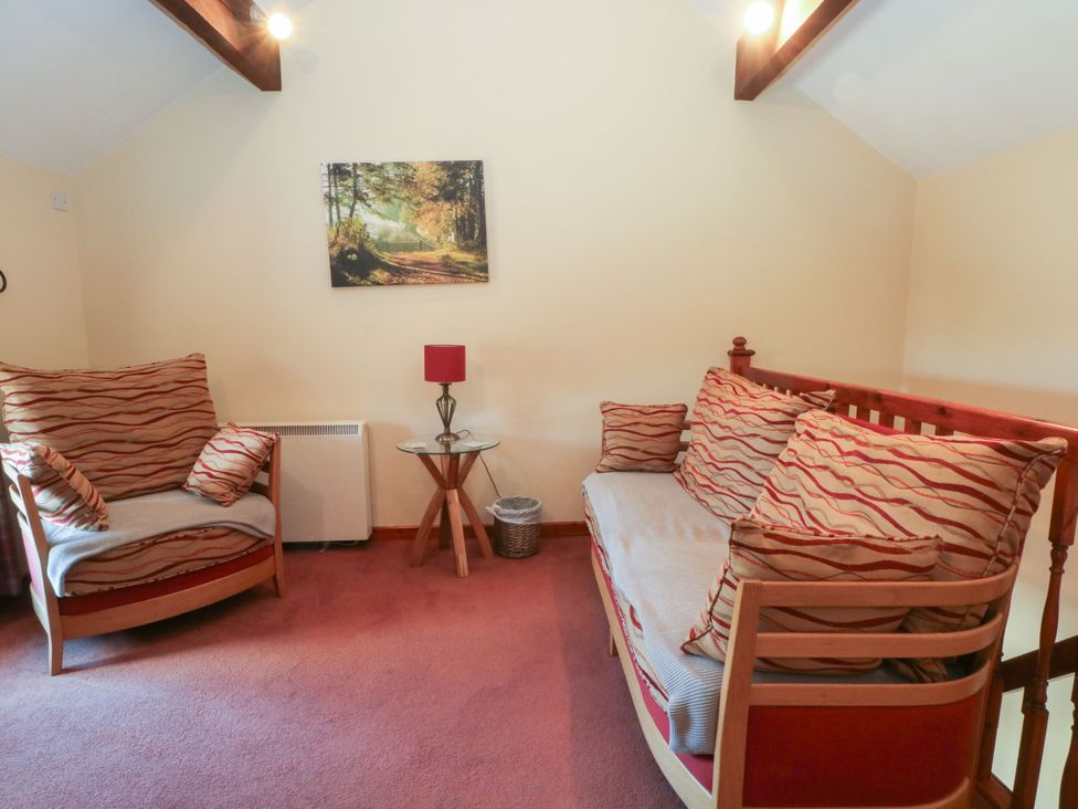 A snug room with sofa and armchair at Pearls Farm One in Wildboarclough near Macclesfield