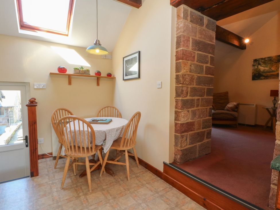 A dining area with a table and chairs at Pearls Farm One in Wildboarclough near Macclesfield