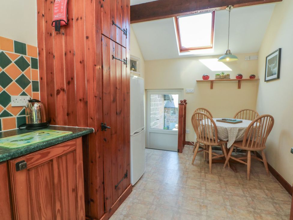 A kitchen with a table and chairs at Pearls Farm One in Wildboarclough near Macclesfield