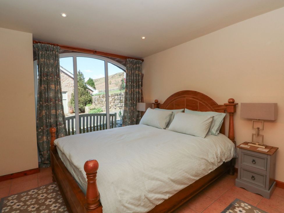 A bedroom with a bed and bedside tables at Pearls Farm One Wildboarclough near Macclesfield