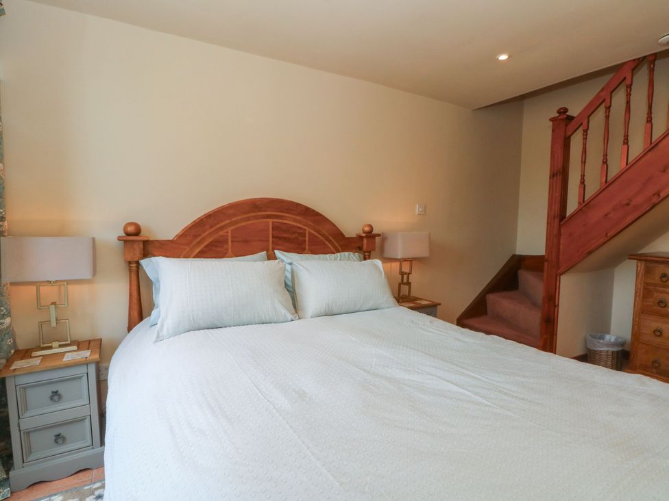A bedroom with a bed and lamp at Pearls Farm One in Wildboarclough near Macclesfield